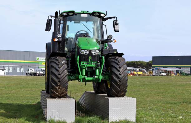 Basiliano, Italy. March 8,  2025. New John Deere tractor on display outside the official dealership of the american corporation.