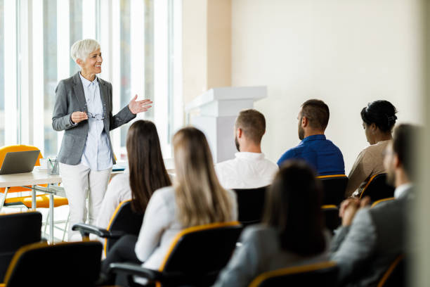 istock Happy female CEO giving a presentation in board room. 2204664954