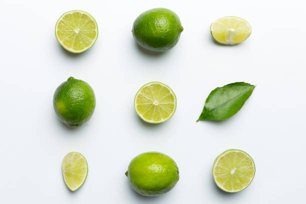 istock Lime fruits with green leaf and cut in half slice isolated on white background. Top view. Flat lay with copy space 2204666682