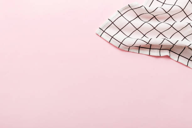 istock top view with white empty kitchen napkin isolated on table background. Folded cloth for mockup with copy space, Flat lay. Minimal style 2204666744