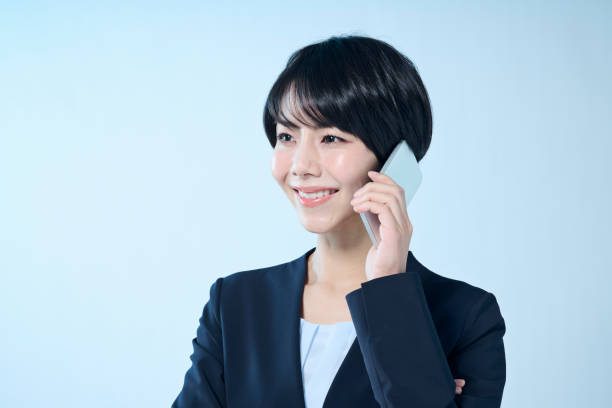 istock A female office worker with short hair operating a smartphone 2204669021