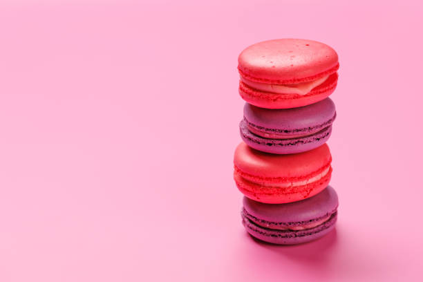 istock A delightful assortment of colorful macaroons arranged on a soft pink background 2204670478