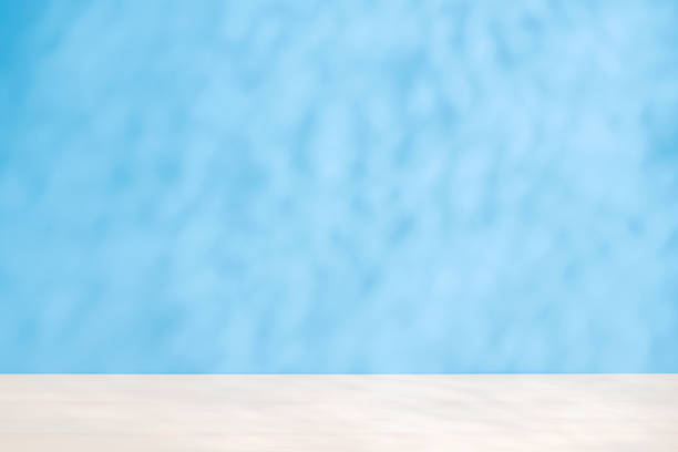 istock Template with empty table and wall with natural shadow and sunny glare 2204670538