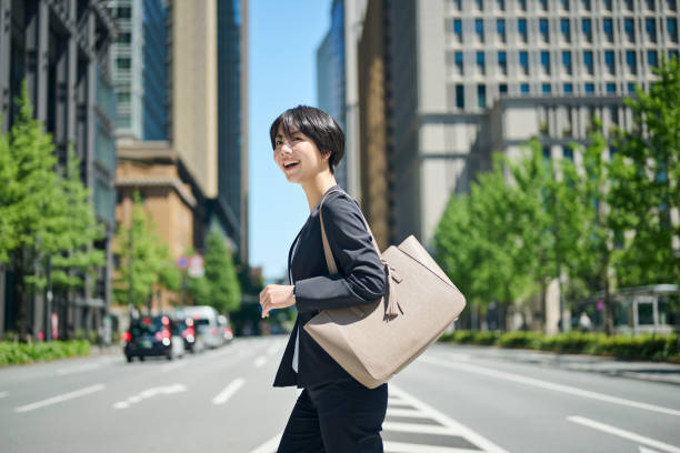istock A female office worker in her 30s walking through a business district 2204670635