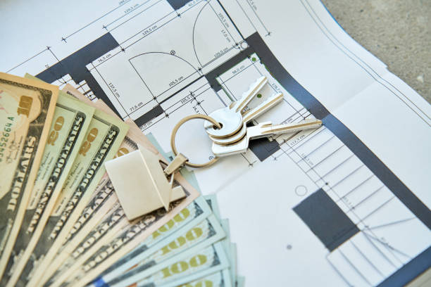 istock House keys and dollar banknotes on architectural blueprint 2204670711