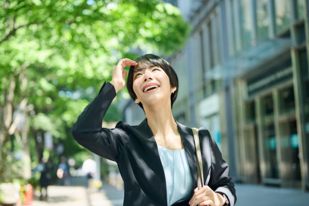 istock A female office worker in her 30s walking through a business district 2204670750