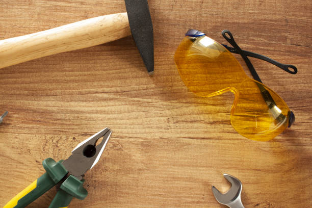istock Working tools on wooden background. glasses, pliers, hammer, screwdriver. construction, repair concept 2204671225