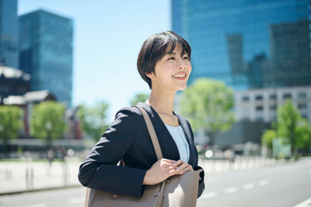 istock A female office worker in her 30s walking through a business district 2204671521