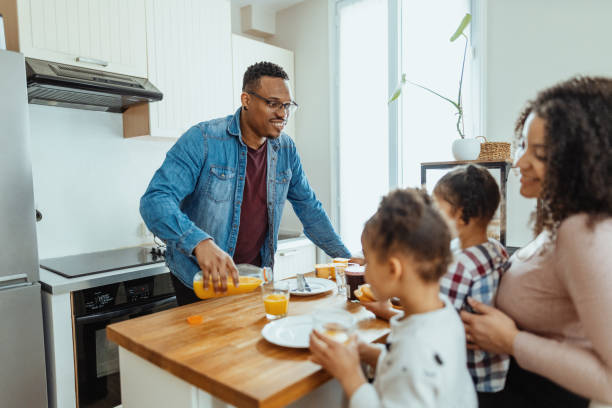 istock Family with two little daughters enjoying breakfast together 2204672262