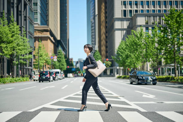 istock A female office worker in her 30s walking through a business district 2204672277