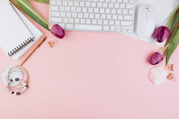 istock Flat lay, top view office table desk frame. Feminine desk workspace with succulent, laptop, glasses, diary and golden clips on pink background 2204672669