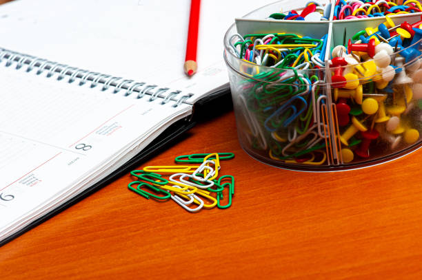 Notebook with calendar and colored paper clips and push pins