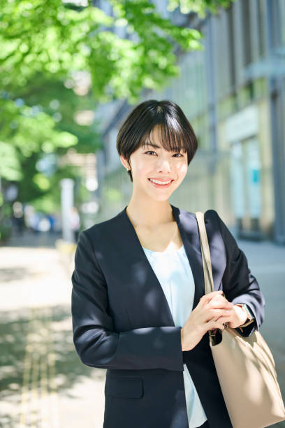 istock A female office worker in her 30s walking through a business district 2204673160