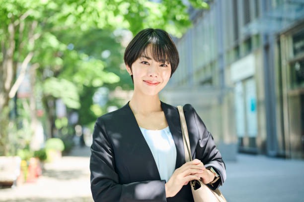 istock A female office worker in her 30s walking through a business district 2204673449