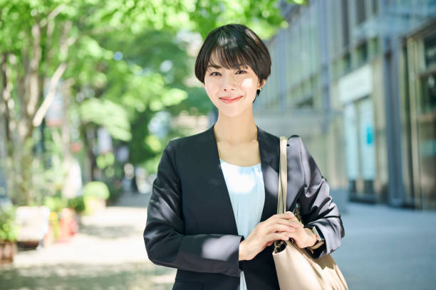 istock A female office worker in her 30s walking through a business district 2204674258