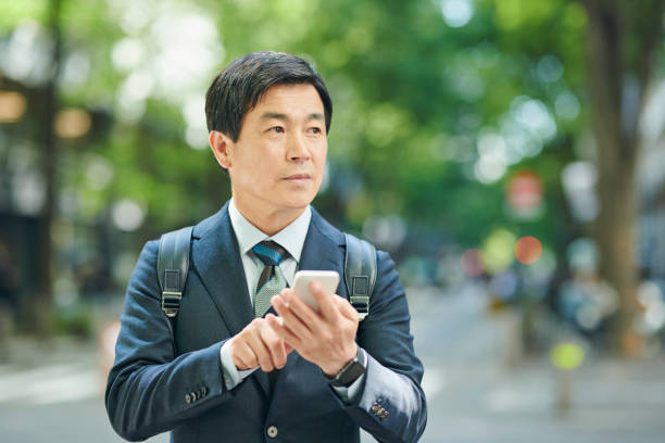 istock A 50-something office worker walking around town while on the phone 2204675132