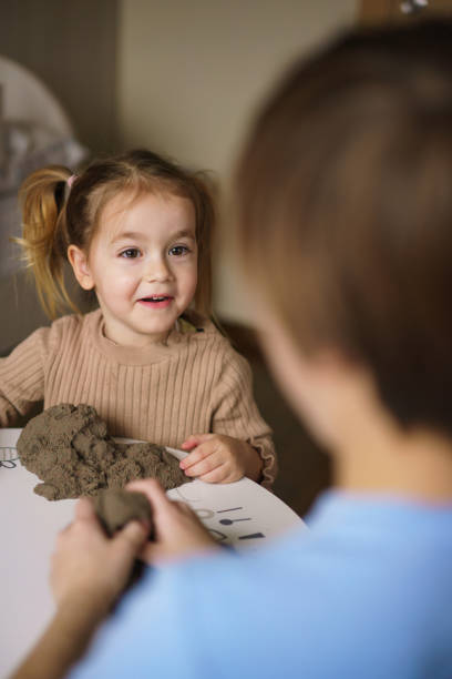 istock Children playing with kinetic sand 2204675142