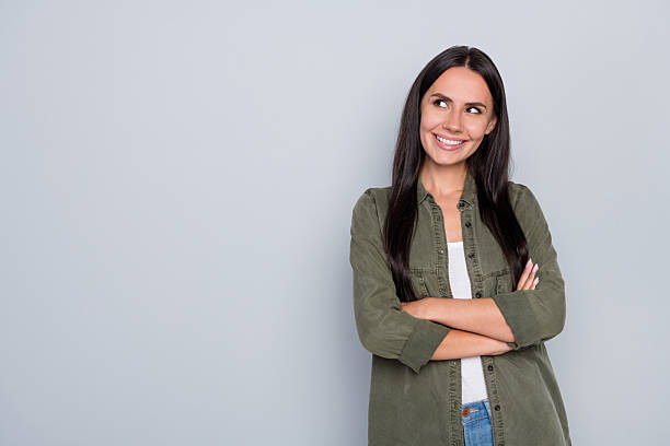 istock Portrait of charming positive lady folded hands look interested empty space isolated on grey color background 2204675577