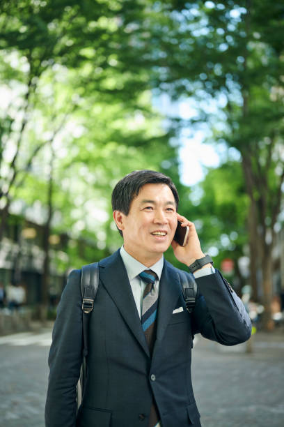 istock A 50-something office worker walking around town while on the phone 2204675957
