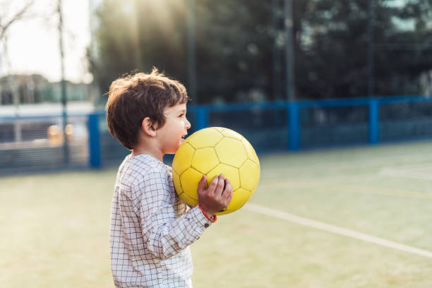 Children playing soccer on the meadow