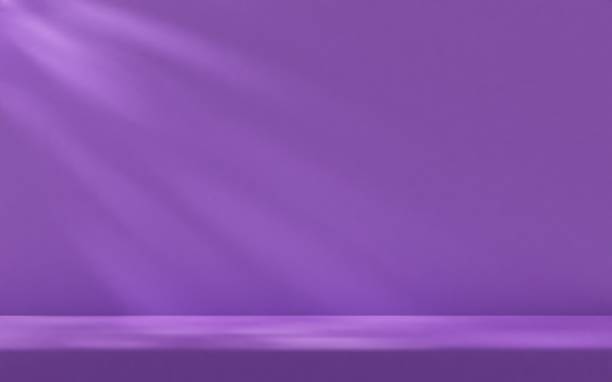 istock Purple studio room wall, illuminated by sunlight through foliage with tabletop. Product presentation template. 2204676759