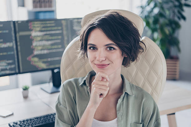 istock Portrait of attractive confident experienced girl hacker coder quality assurance manager qa touching chin at work place station indoors 2204676792