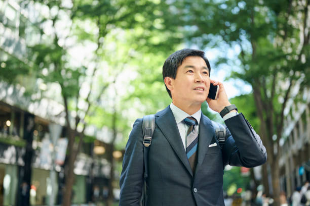 istock A 50-something office worker walking around town while on the phone 2204677071