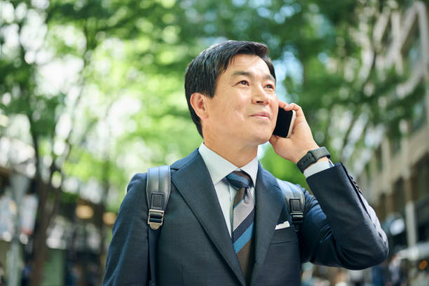 istock A 50-something office worker walking around town while on the phone 2204677254