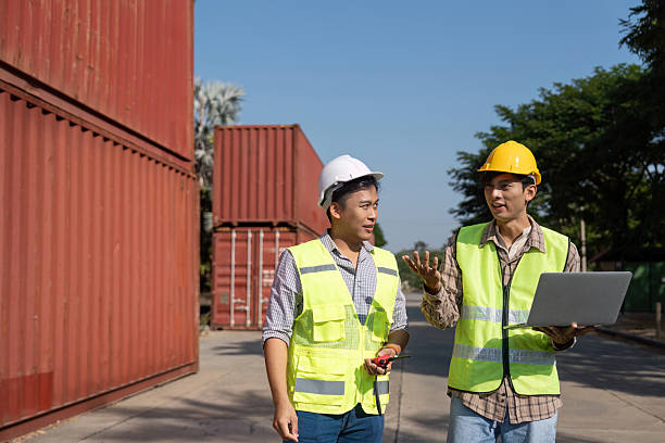 istock Strategic Planning. Engineers discussing logistics using a laptop at a site. 2204681371