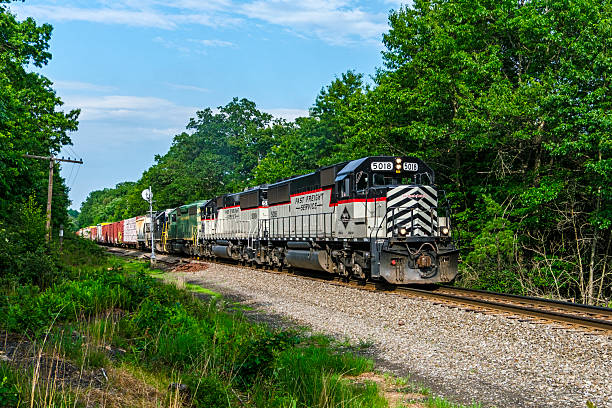 Jim Thorpe PA, USA - July 6th, 2023:  Regional railroad, Reading & Northern's NRFF Fast Freight service between Reading and Pittston has corporate-coloured 5018 & 5019 leading 3054 and 2017 as they pass a signal in rural northeastern Pennsylvania. \nThe Reading Blue Mountain & Northern Railroad (RBMN) is a privately-owned regional railroad serving a variety of customers in Eastern Pennsylvania. It operates both freight and passenger train service.