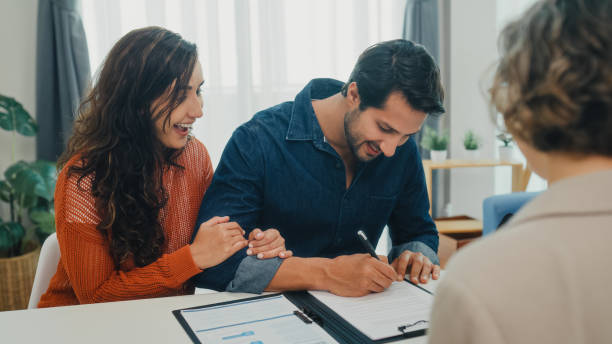 istock Financial advisor using tablet discussing about life insurance domestic finances and handshake agreement with young couple in living room at home. Financial planning and lifestyles concept. 2204684481
