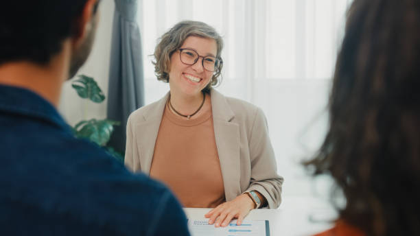 istock Financial advisor using digital tablet discussing about life insurance and domestic finances with young couple in living room at home. Financial planning and lifestyles concept. 2204684488