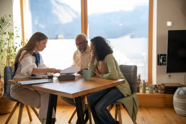 istock Insurance agent at home with an elderly couple 2204685543