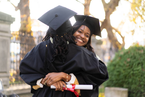 istock Two African-American students hugging in happiness at graduating 2204685644