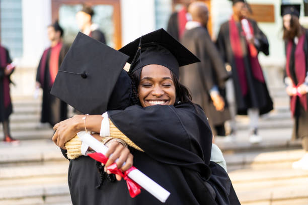 istock Two female graduates embracing on the university steps 2204685647
