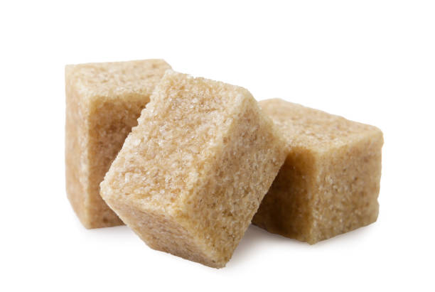 istock Brown sugar cubes close-up on a white. Isolated 2204685773