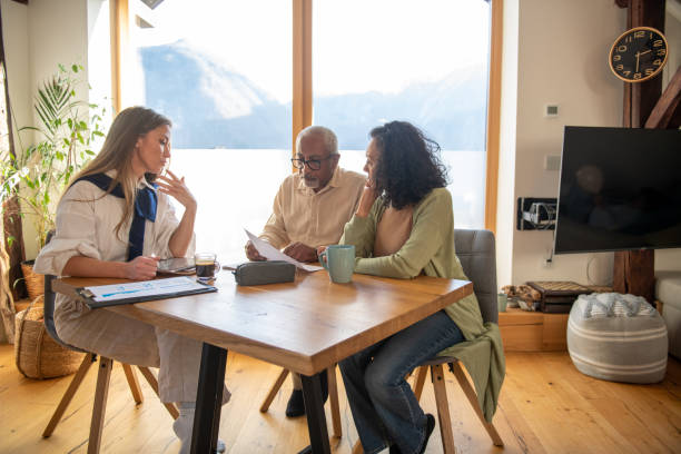 istock Insurance agent at home with an elderly couple 2204686022