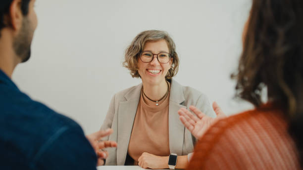 istock Financial advisor using digital tablet discussing about life insurance and domestic finances with young couple in living room at home. Financial planning and lifestyles concept. 2204686420