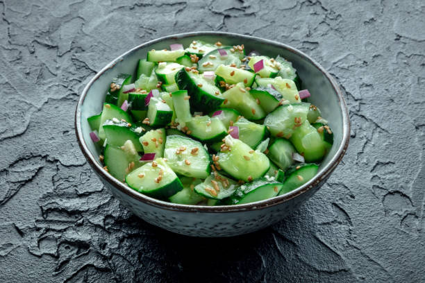 istock Smashed cucumber salad with red onion and sesame seeds 2204687034