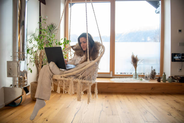 istock Woman working from home sitting in her swing seat 2204687967