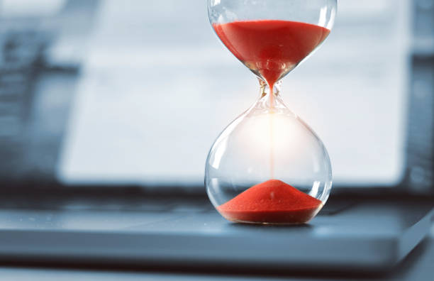 istock Red hourglass on laptop computer. Concept for critical time management 2204689830