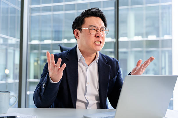 istock Frustrated Businessman Reacting to a Challenge While Working at the Office 2204690494