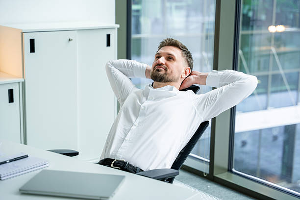 istock Relaxed Businessman Leaning Back in Modern Office Environment 2204690701