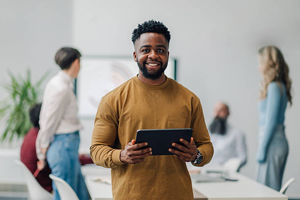 istock Smiling businessman holding digital tablet during office meeting 2204690842