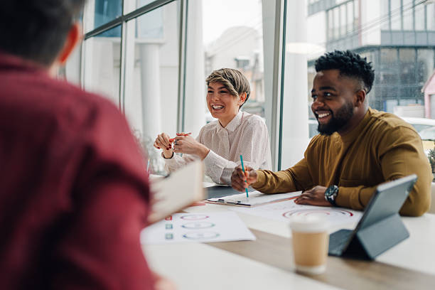istock Smiling business team discussing new project during meeting 2204690855