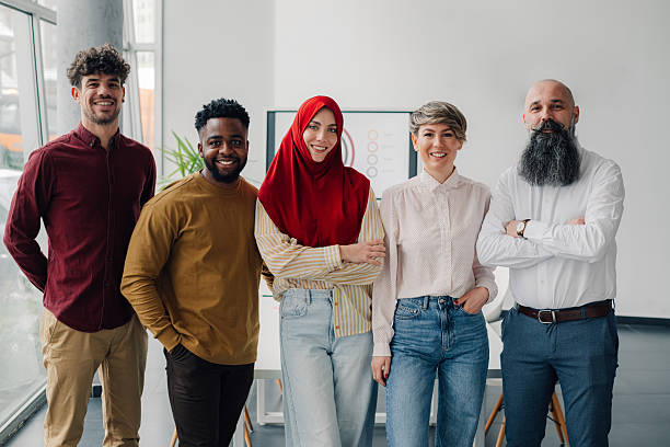 istock Five business colleagues smiling together in modern office 2204690960