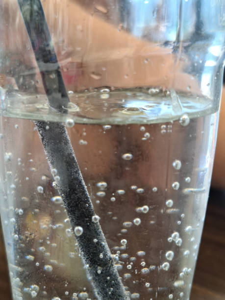 Close-up of carbonated water whit a straw outdoors