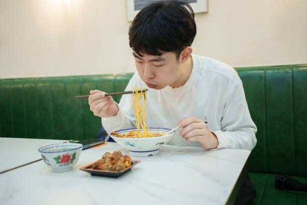 istock Male customer enjoying satay noodles 2204695918