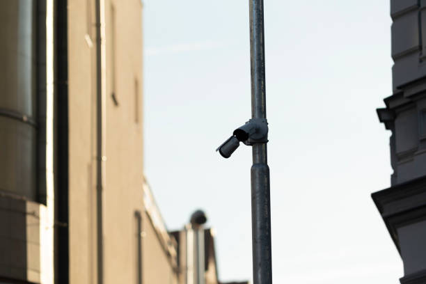 istock Surveillance cameras are securely mounted high on pole at outdoor area 2204696756