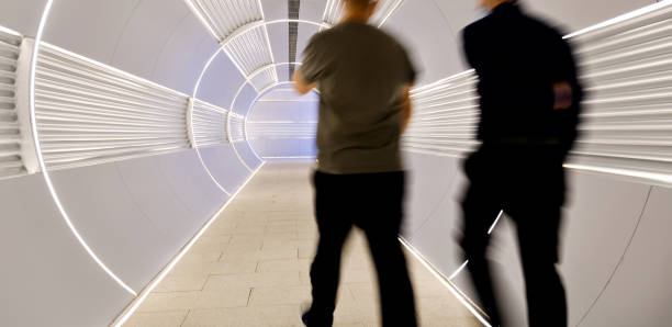 istock Men walking in corridor tunnel 2204697454
